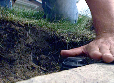 Superior CO sprinkler repair specialist checks the clearance for a new toro pop up head