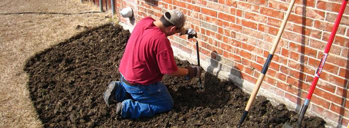 irrigation contractor installing a new riser during a sprinkler repair in Lafayette, Colorado
