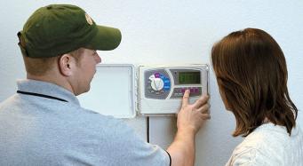 Lafayette sprinkler repair technician educates homeowner after replacing a rain bird controller unit